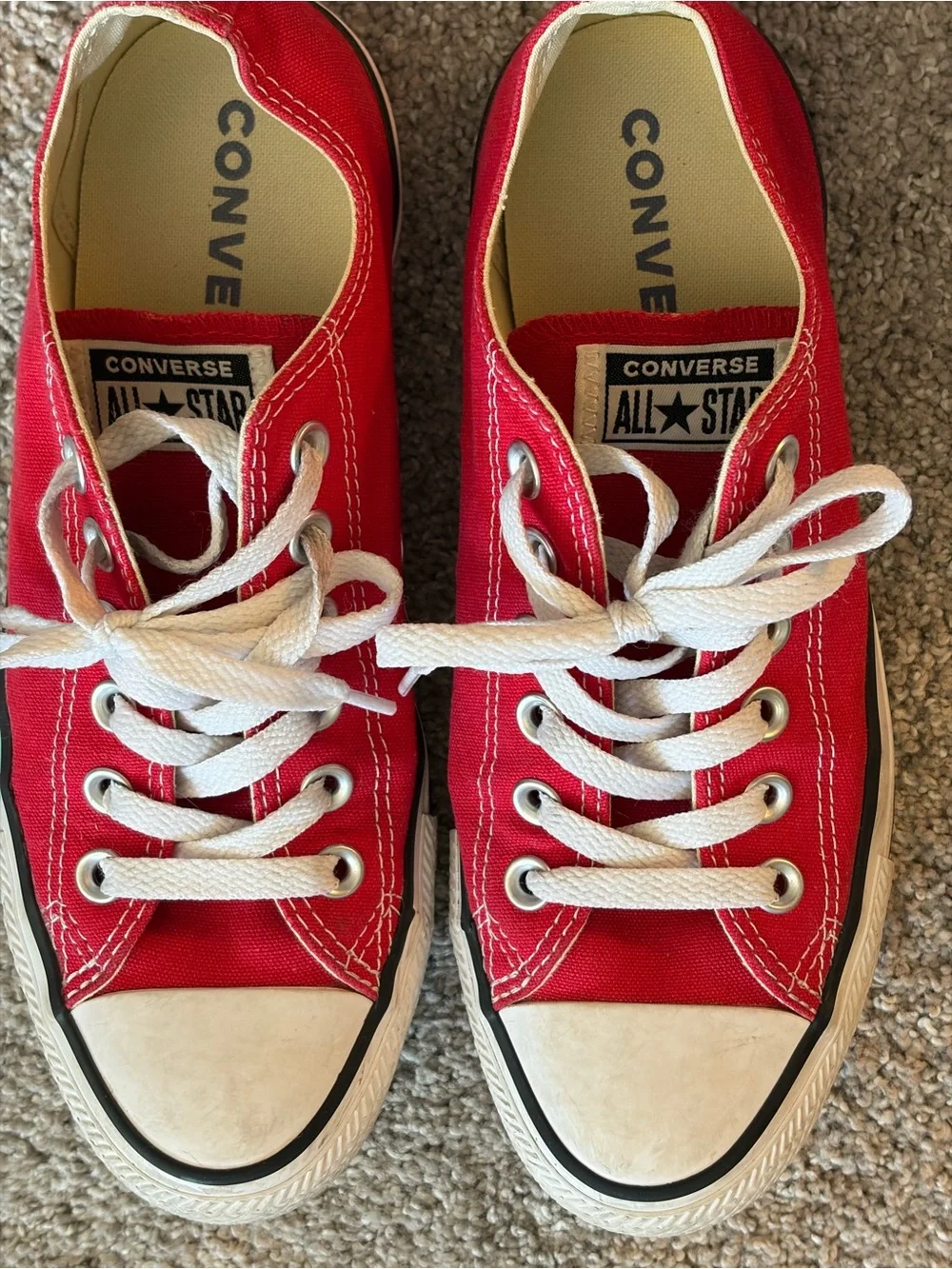 Converse red low-top sneakers with white laces